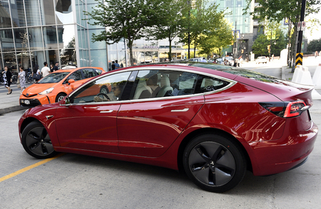 Darlene Clarke of Foreseeson Technology takes a Tesla model 3 for a test drive outside of the Clean Energy Ministerial in Vancouver on May 27, 2019. Photo by Jennifer Gauthier